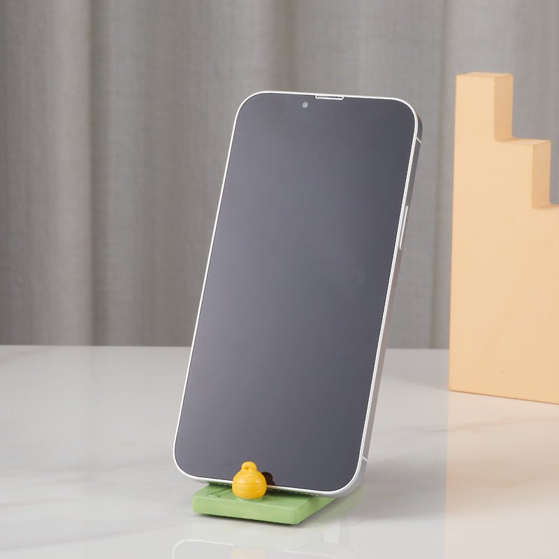 Panda figurine holding a phone in portrait orientation