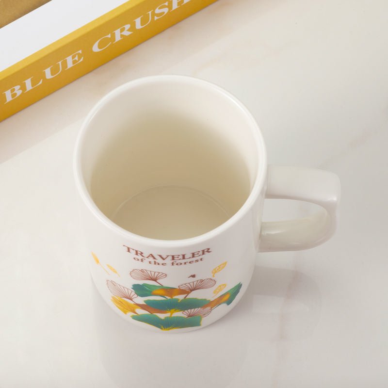 Top view of Traveler of the Forest ceramic mug with colorful leaf design