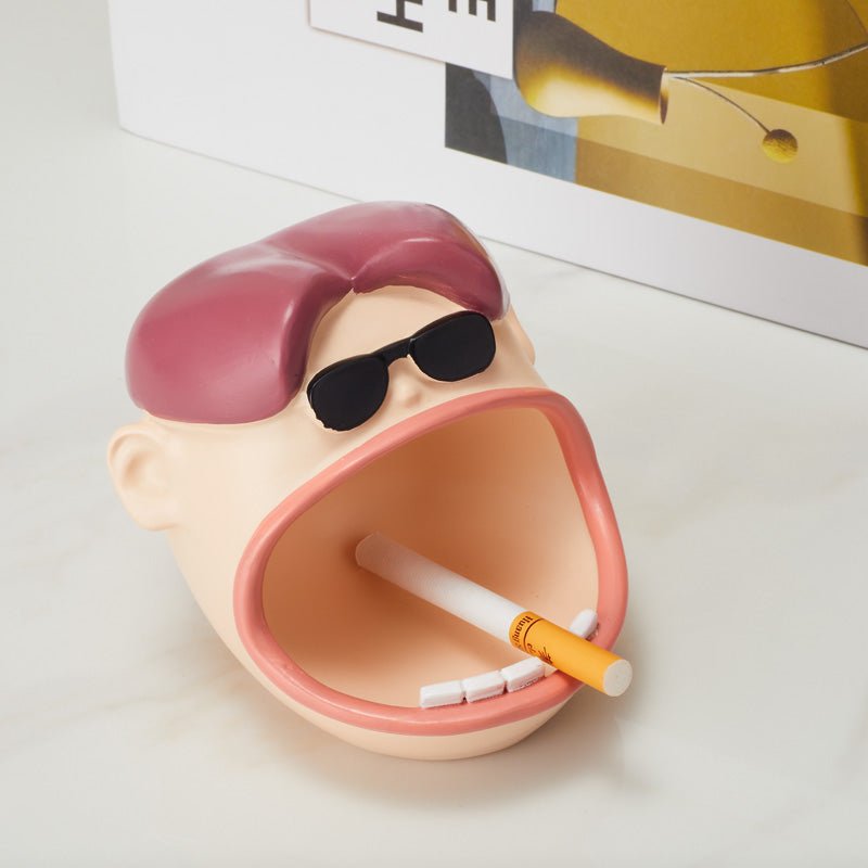 Top view of Funny Big Mouth Dude Ashtray with a cigarette