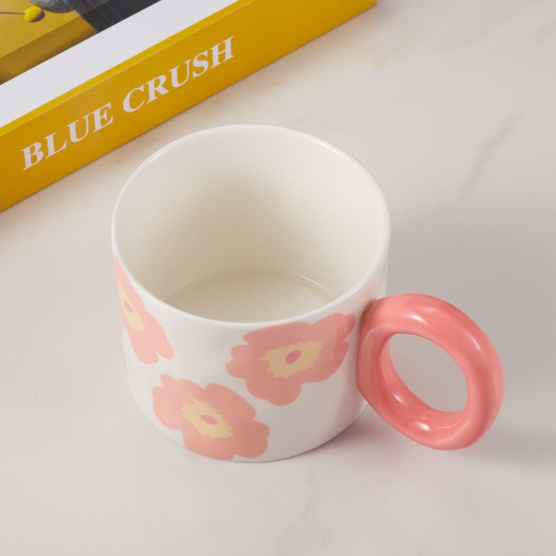 Top view of floral-patterned ceramic mug with pink handle