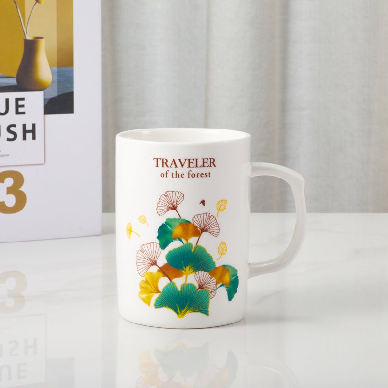 Side view of Traveler of the Forest ceramic mug with colorful leaf design